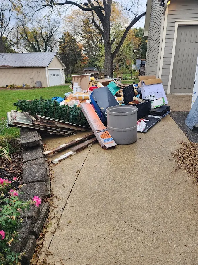 Dumpster being loaded with debris for 10 Yard Dumpster Rental in Hastings